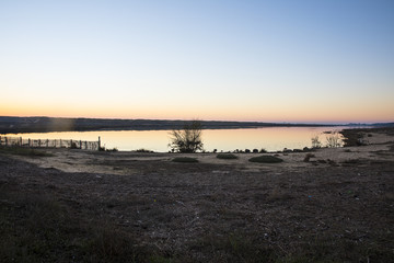sunset with shy reflection in still water over nature reserve Casse de la Belle Henriette, Vendee, France