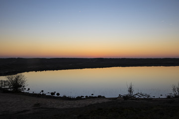 sunset with shy reflection in still water over nature reserve Casse de la Belle Henriette, Vendee,...