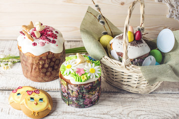 Fototapeta na wymiar Festive table with cake and colorful eggs on wooden background. Concept of Orthodox Easter