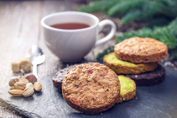 Homemade Christmas or New Year holiday oatmeal cookies with pistachios and chocolate. Concept of festive desserts