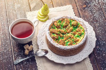 Homemade Christmas or New Year holiday pear pie decorated in a rustic style. Concept of festive desserts