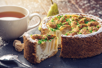 Homemade Christmas or New Year holiday pear pie decorated in a rustic style. Concept of festive desserts