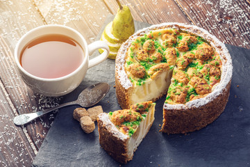 Homemade Christmas or New Year holiday pear pie decorated in a rustic style. Concept of festive desserts