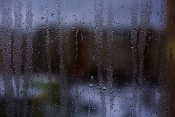 Misted window glass in drops of water as a background