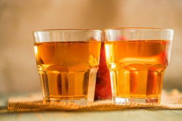 Fresh apple juice or cider in glasses on table