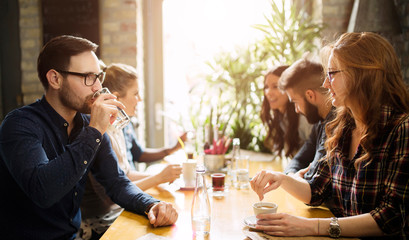 Happy colleagues from work socializing in restaurant