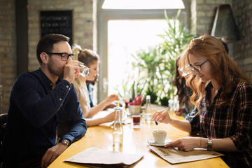 Happy colleagues from work socializing in restaurant