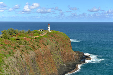 Fototapeta na wymiar White Lighthouse and Blue Sea - Kilauea Lighthouse against blue ocean and blue sky, Kauai, Hawaii, USA