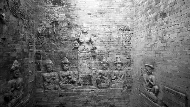 Interior motion and panning the walls showing bas reliefs of Lakshmi, Vishnu's consort, flanked by devotees.