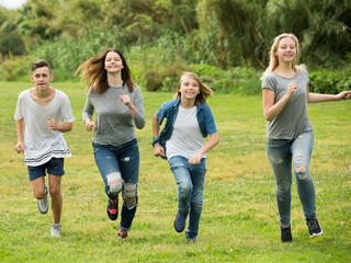 Fototapeta premium Friends having fun and running in park
