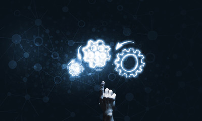 Glowing cogwheel mechanism icon on dark background as symbol of teamwork