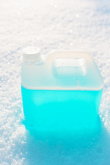 bottle with non-freezing windshield washer fluid, snow background