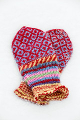 Beautiful jacquard women's mittens in the snow
