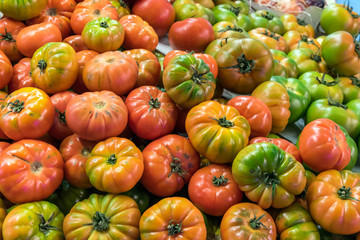 Red and green tomatoes for sale at a market in Madrid, Spain