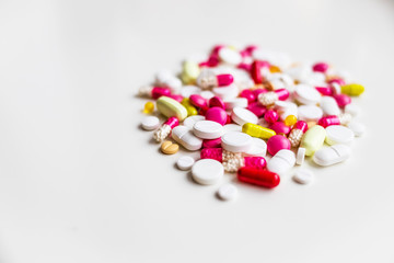 Assorted pharmaceutical medicine pills, tablets and capsules.Pills background. Heap of assorted various medicine tablets and pills different colors on white background. Health care.Top view.Copy space