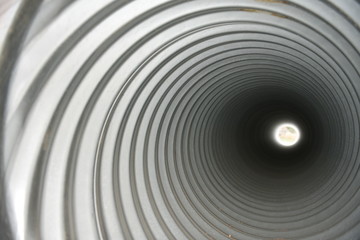 Metal pipe interior, tunnel, tube, swirling, spiral, distance light	