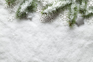 Christmas background - snowflakes and spruce tree on white snow