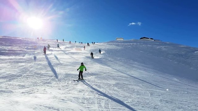 group of skiers in high mountains, prepared piste and sunny day. 4k