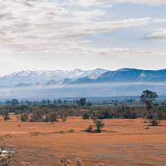 Valley view from the river and the mountains in the background at sunrise. Georgia. Caucasus mountains