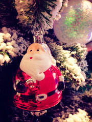 Close up Christmas fastival's ornament, Santa doll, shiny ball hang on the pine tree vertical view.