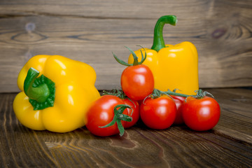 Paprika tomato green onion background - summer garden harvest. Red, yellow and yellow pepper, tomatoes, red onion,