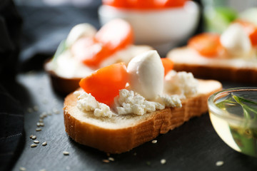 Delicious sandwich with cherry tomato and mozzarella on table, closeup