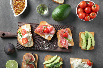 Delicious sandwiches on grey background, top view