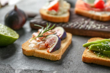 Delicious sandwich with fig and lunch meat on table, closeup