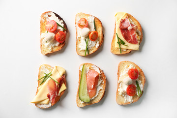 Delicious sandwiches on white background, top view