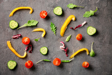 Ingredients for delicious salad on grey background, top view