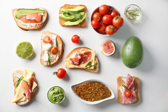 Delicious sandwiches on white background, top view