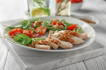 Plate with meat and delicious fresh salad on table