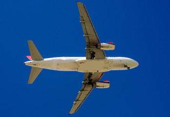 The plane on a background of blue sky and white clouds.