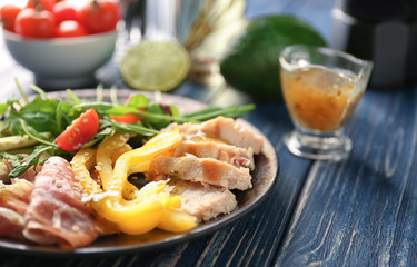 Plate with meat and delicious fresh salad on table, closeup