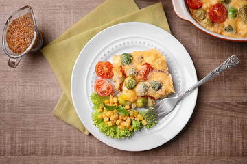 Plate of tasty baked Brussels sprouts with cheese on table