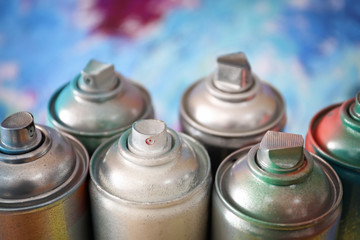 Aluminum aerosol cans with paints, closeup