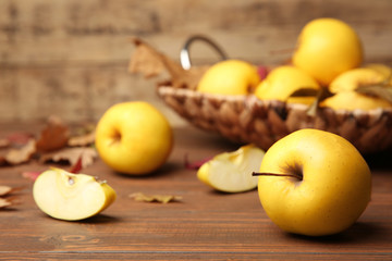 Naklejka na ściany i meble Ripe yellow apple on wooden table, closeup
