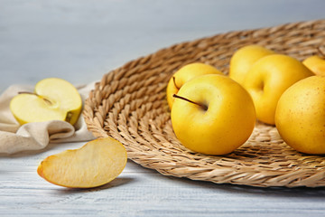 Ripe yellow apples on table