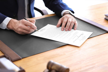Male notary signing marriage contract, closeup