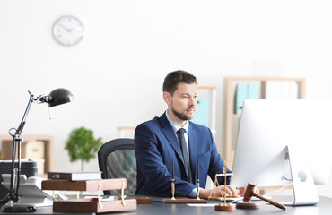 Young male notary working in office