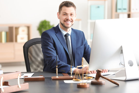 Young Male Notary Working In Office