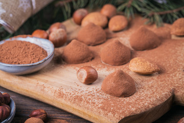 Homemade chocolate truffles, nuts, almonds and cocoa powder