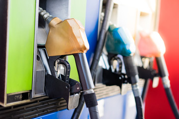 Colorful Petrol pump filling nozzles.Gas station in a service in warm sunset.