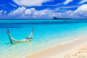 Fototapeta na wymiar Relaxing tropical holidays with hammock in the turquoise sea.