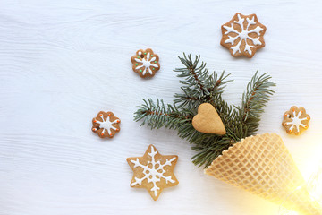concept of New Year ice cream/ salute from spruce branches in a waffle horn surrounded by a festive cookie