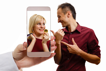 Bitcoin on mobile phone smart phone mobile device with bitcoin currency symbol in hands of