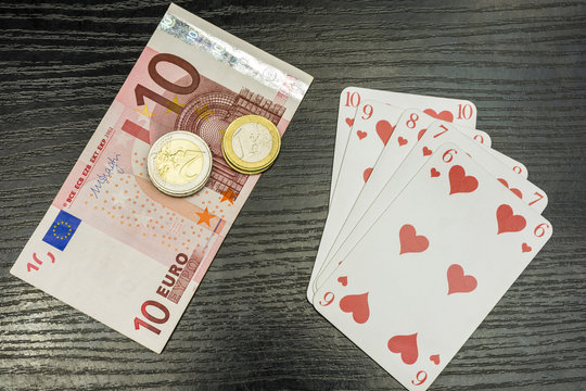 Poker - Straight flush, money and euro coins.