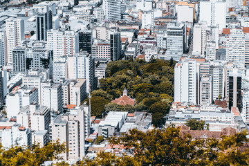 View from high point of modern urban cityscape on very bright summer day: multiple multistorey...