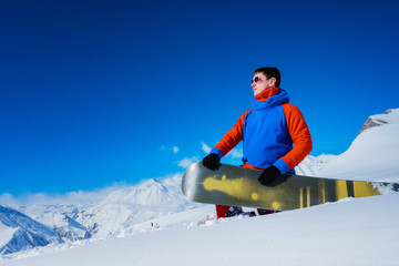 Stylish athlete snowboarder with glasses