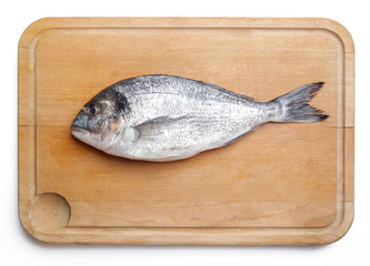  Gilt-head bream fish on the wooden cutting board